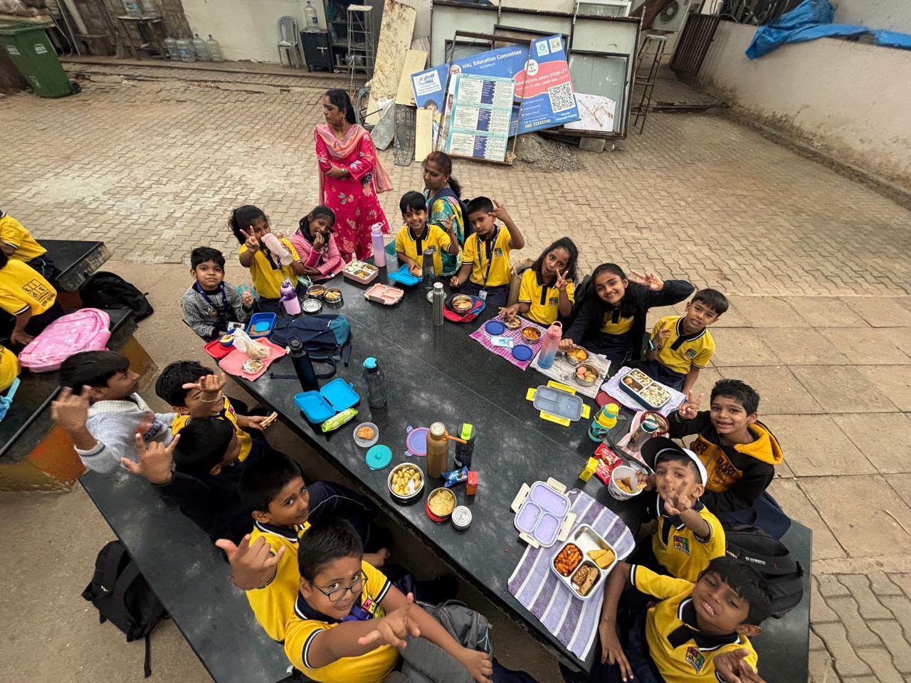 Children and teachers sharing lunch together on a school trip